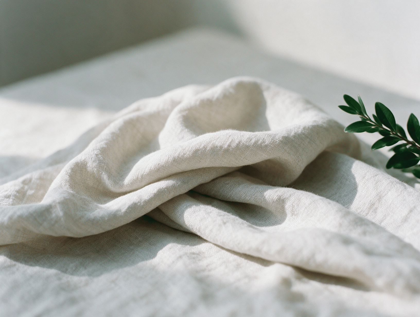 Soft folded pale linen with gentle light and shadow